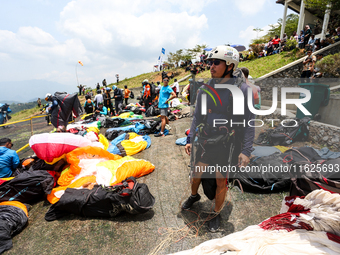 A number of paragliding athletes prepare to take part in a paragliding competition in Sumedang, Indonesia, on October 1, 2024. The paraglidi...