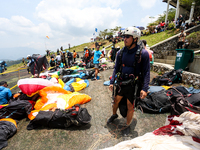 A number of paragliding athletes prepare to take part in a paragliding competition in Sumedang, Indonesia, on October 1, 2024. The paraglidi...