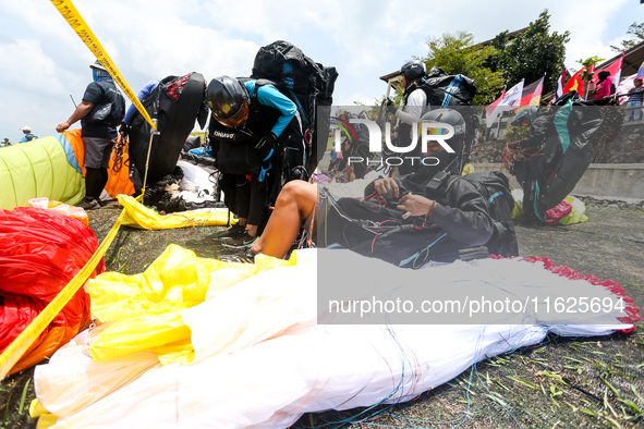 A number of paragliding athletes prepare to take part in a paragliding competition in Sumedang, Indonesia, on October 1, 2024. The paraglidi...