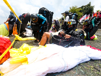 A number of paragliding athletes prepare to take part in a paragliding competition in Sumedang, Indonesia, on October 1, 2024. The paraglidi...