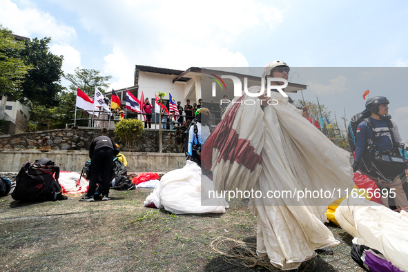 A number of paragliding athletes prepare to take part in a paragliding competition in Sumedang, Indonesia, on October 1, 2024. The paraglidi...