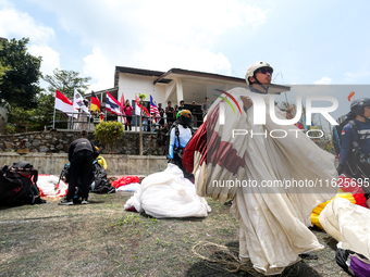 A number of paragliding athletes prepare to take part in a paragliding competition in Sumedang, Indonesia, on October 1, 2024. The paraglidi...