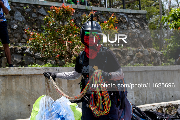 A number of paragliding athletes prepare to take part in a paragliding competition in Sumedang, Indonesia, on October 1, 2024. The paraglidi...