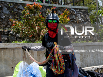 A number of paragliding athletes prepare to take part in a paragliding competition in Sumedang, Indonesia, on October 1, 2024. The paraglidi...