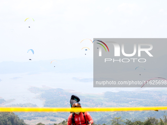 A paragliding athlete prepares to take part in a paragliding competition in Sumedang, Indonesia, on October 1, 2024. The paragliding competi...