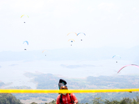 A paragliding athlete prepares to take part in a paragliding competition in Sumedang, Indonesia, on October 1, 2024. The paragliding competi...