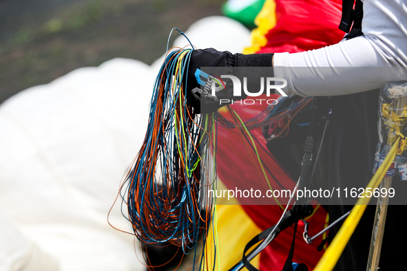 A paragliding athlete prepares to take part in a paragliding competition in Sumedang, Indonesia, on October 1, 2024. The paragliding competi...