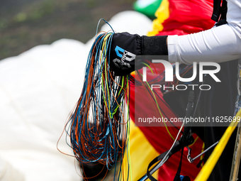 A paragliding athlete prepares to take part in a paragliding competition in Sumedang, Indonesia, on October 1, 2024. The paragliding competi...