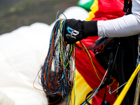 A paragliding athlete prepares to take part in a paragliding competition in Sumedang, Indonesia, on October 1, 2024. The paragliding competi...