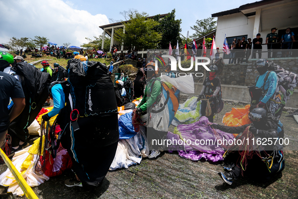 A number of paragliding athletes prepare to take part in a paragliding competition in Sumedang, Indonesia, on October 1, 2024. The paraglidi...