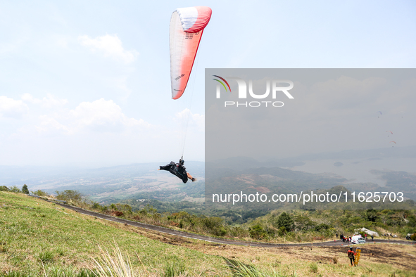 A paragliding athlete takes part in a paragliding competition in Sumedang, Indonesia, on October 1, 2024. Various athletes from countries in...