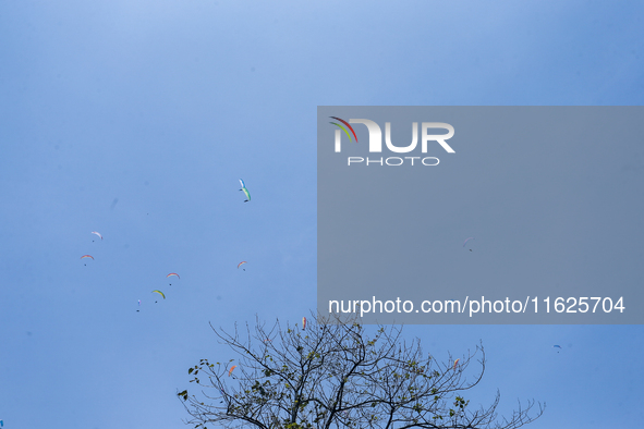 A number of paragliding athletes take part in a paragliding competition in Sumedang, Indonesia, on October 1, 2024. Various athletes from co...