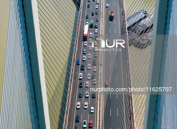 A large number of vehicles move slowly along an expressway in Huai'an, China, on October 1, 2024. 