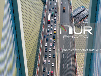 A large number of vehicles move slowly along an expressway in Huai'an, China, on October 1, 2024. (