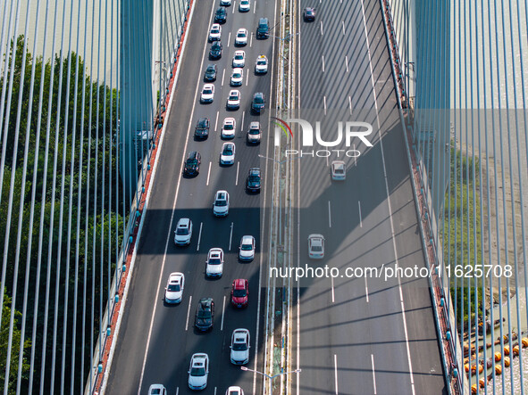 A large number of vehicles move slowly along an expressway in Huai'an, China, on October 1, 2024. 