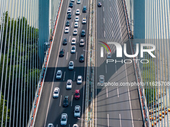 A large number of vehicles move slowly along an expressway in Huai'an, China, on October 1, 2024. (