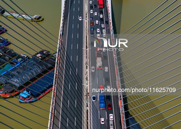 A large number of vehicles move slowly along an expressway in Huai'an, China, on October 1, 2024. 