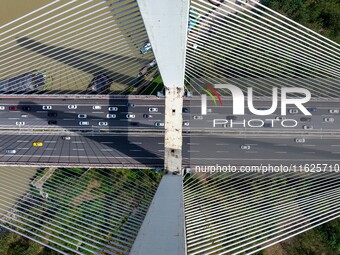 A large number of vehicles move slowly along an expressway in Huai'an, China, on October 1, 2024. (