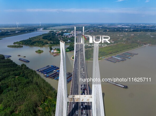 A large number of vehicles move slowly along an expressway in Huai'an, China, on October 1, 2024. 