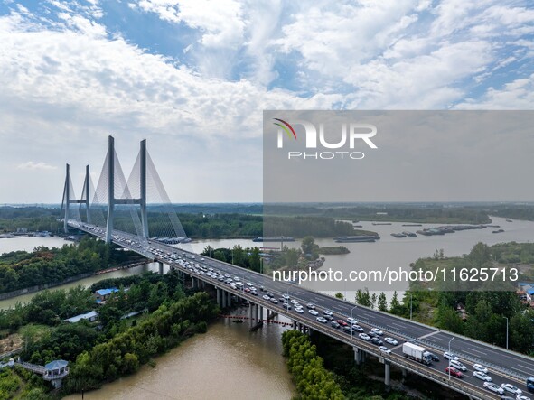 A large number of vehicles move slowly along an expressway in Huai'an, China, on October 1, 2024. 