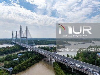 A large number of vehicles move slowly along an expressway in Huai'an, China, on October 1, 2024. (