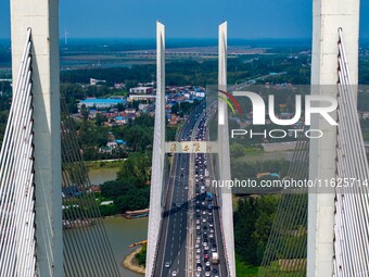 A large number of vehicles move slowly along an expressway in Huai'an, China, on October 1, 2024. (