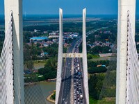 A large number of vehicles move slowly along an expressway in Huai'an, China, on October 1, 2024. (