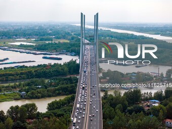 A large number of vehicles move slowly along an expressway in Huai'an, China, on October 1, 2024. (