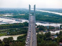 A large number of vehicles move slowly along an expressway in Huai'an, China, on October 1, 2024. (