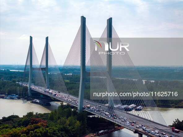 A large number of vehicles move slowly along an expressway in Huai'an, China, on October 1, 2024. 