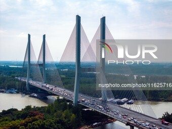 A large number of vehicles move slowly along an expressway in Huai'an, China, on October 1, 2024. (