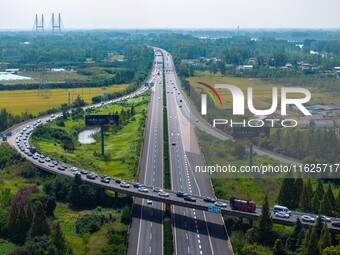 A large number of vehicles move slowly along an expressway in Huai'an, China, on October 1, 2024. (