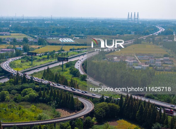 A large number of vehicles move slowly along an expressway in Huai'an, China, on October 1, 2024. 