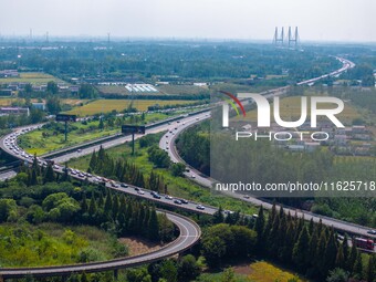 A large number of vehicles move slowly along an expressway in Huai'an, China, on October 1, 2024. (