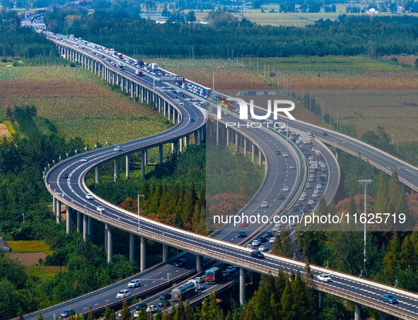 A large number of vehicles move slowly along an expressway in Huai'an, China, on October 1, 2024. 