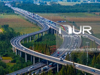 A large number of vehicles move slowly along an expressway in Huai'an, China, on October 1, 2024. (