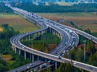 A large number of vehicles move slowly along an expressway in Huai'an, China, on October 1, 2024. (