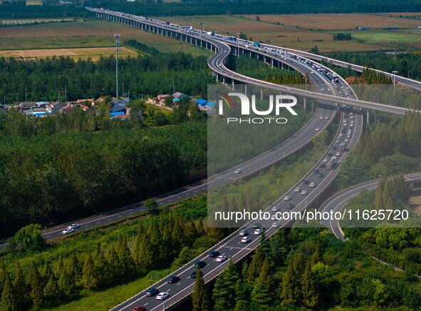 A large number of vehicles move slowly along an expressway in Huai'an, China, on October 1, 2024. 