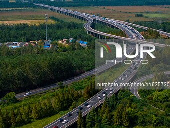 A large number of vehicles move slowly along an expressway in Huai'an, China, on October 1, 2024. (