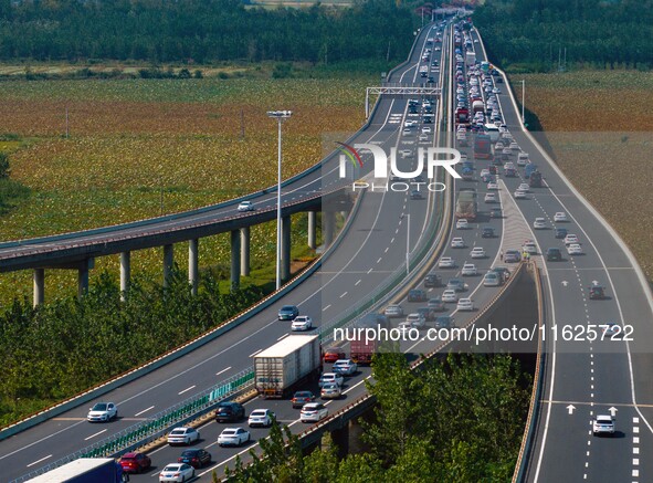 A large number of vehicles move slowly along an expressway in Huai'an, China, on October 1, 2024. 