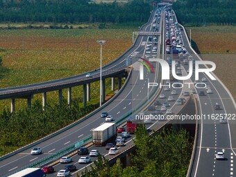 A large number of vehicles move slowly along an expressway in Huai'an, China, on October 1, 2024. (