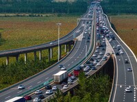 A large number of vehicles move slowly along an expressway in Huai'an, China, on October 1, 2024. (