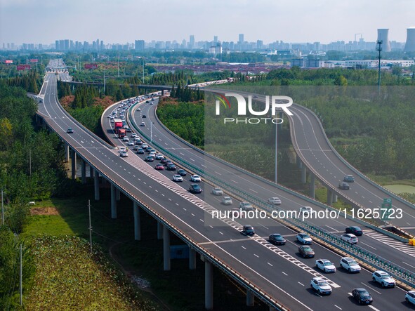 A large number of vehicles move slowly along an expressway in Huai'an, China, on October 1, 2024. 