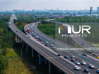 A large number of vehicles move slowly along an expressway in Huai'an, China, on October 1, 2024. (