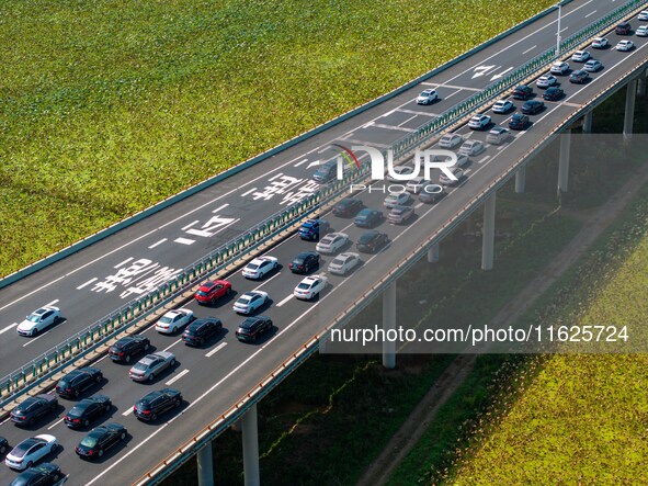 A large number of vehicles move slowly along an expressway in Huai'an, China, on October 1, 2024. 