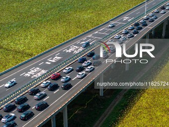 A large number of vehicles move slowly along an expressway in Huai'an, China, on October 1, 2024. (