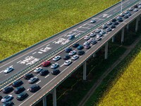 A large number of vehicles move slowly along an expressway in Huai'an, China, on October 1, 2024. (