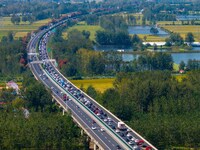 A large number of vehicles move slowly along an expressway in Huai'an, China, on October 1, 2024. (