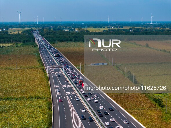 A large number of vehicles move slowly along an expressway in Huai'an, China, on October 1, 2024. 