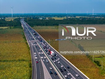 A large number of vehicles move slowly along an expressway in Huai'an, China, on October 1, 2024. (